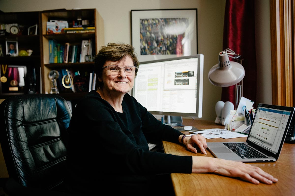 Katalin Karikó working on a laptop at a desk.