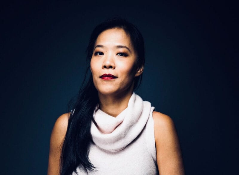 A headshot of Shih-Ching Tsou in a sleeveless white cowl-neck sweater.