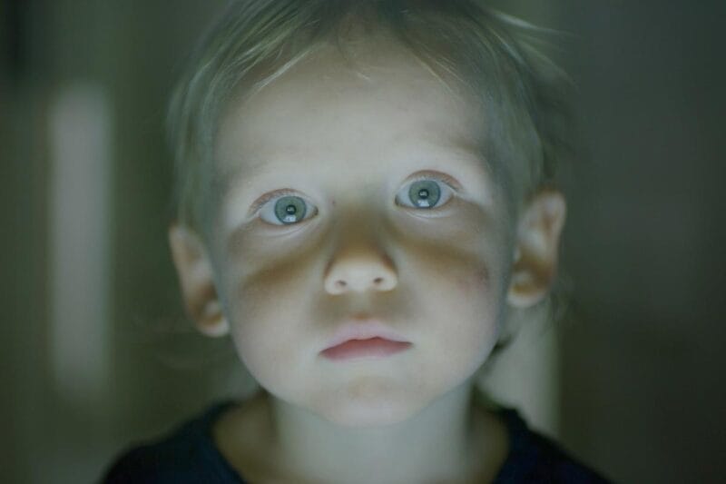 A toddler stares into the camera; a film still from Natalia Almada's film 'Users'