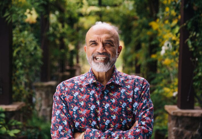 Vishva Dixit with a big smile and a multicolor button-down.