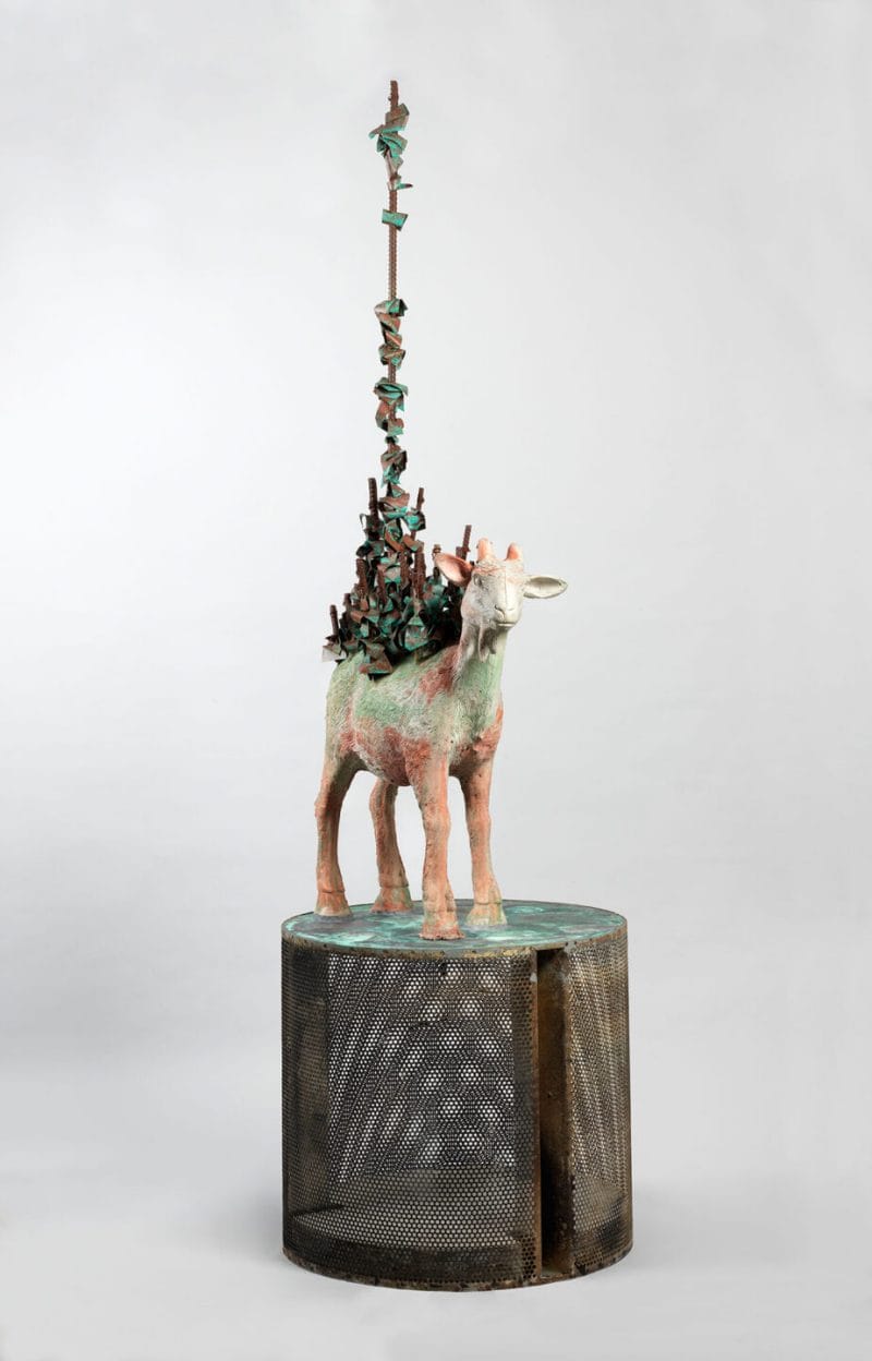 A goat sculpture with rebar sticking out of its back.