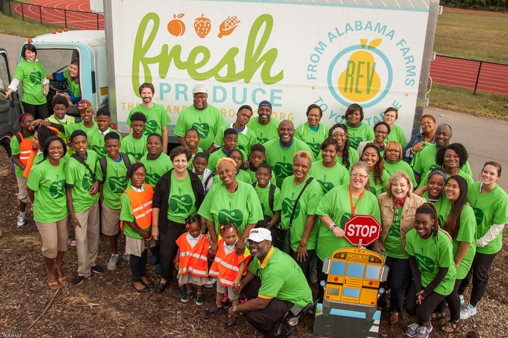 A group photo of Birmingham REACH for Better Health community wearing green shirts.