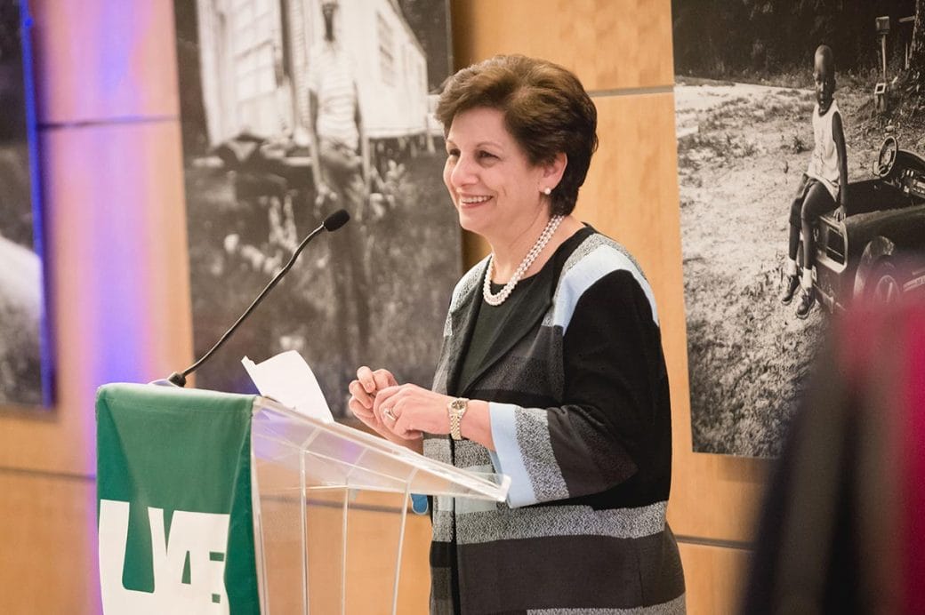 Dr. Mona Fouad standing behind a podium at the National Academy of Medicine.