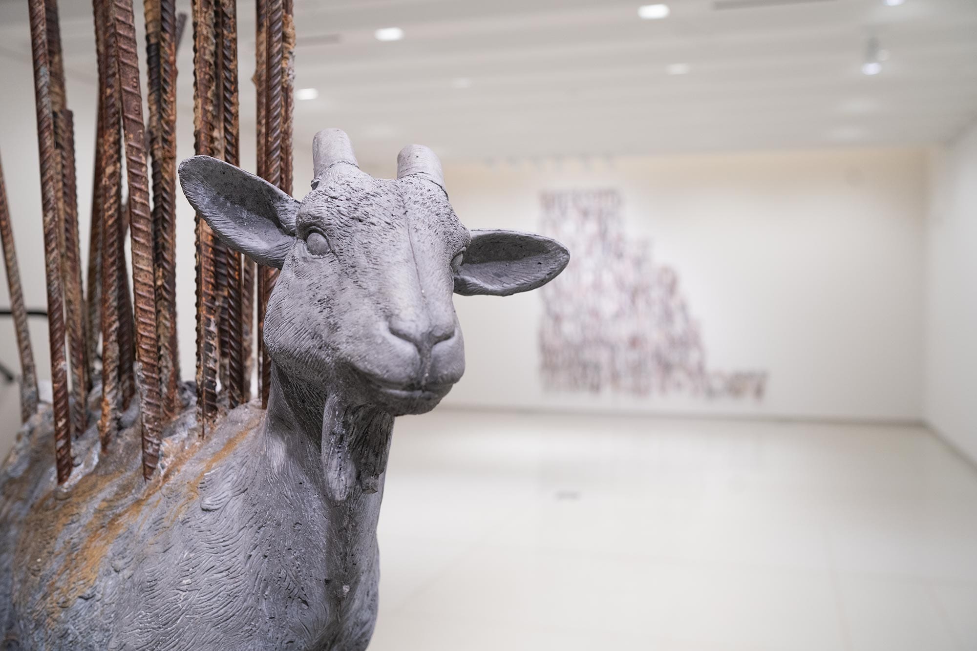 A sculpture of a goat with rebar sticking out of it's back.