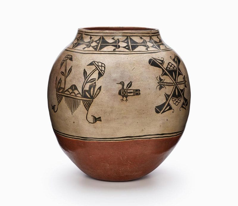 An oval Cochiti jar with black and red painted decoration.