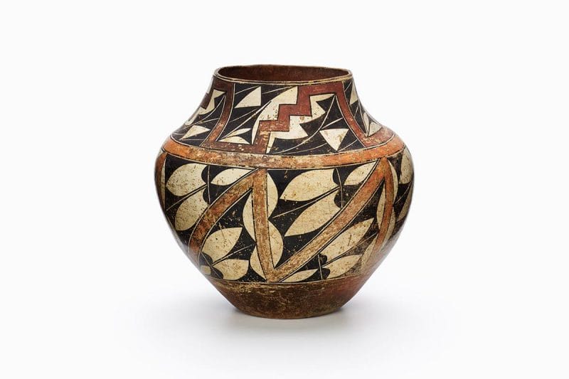 An Acoma jar with red, orange, and black triangles and rain clouds.
