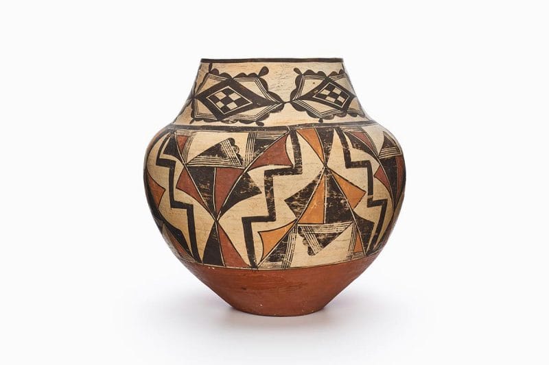 An Acoma jar with interchanging panels of black, red, and orange triangles.