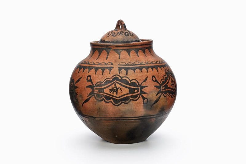 A San Ildefonso red lidded jar with black designs.