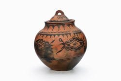 A San Ildefonso lidded jar with black and red clouds and birds.