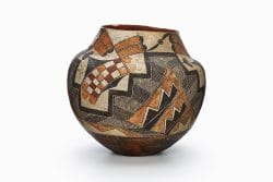 A four-color Acoma or Laguna polychrome jar featuring white slip with black, red, and orange painted decoration.