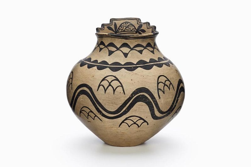 A San Ildefonso pot featuring white slip with black painted decoration.