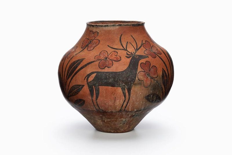 A Zia pot with a rarely-painted deer in the center surrounded by black and brown patterns.