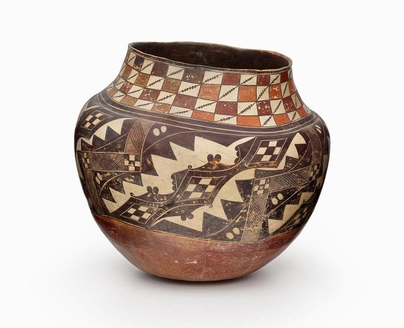 An Acoma jar with black, red, and orange painted decoration.