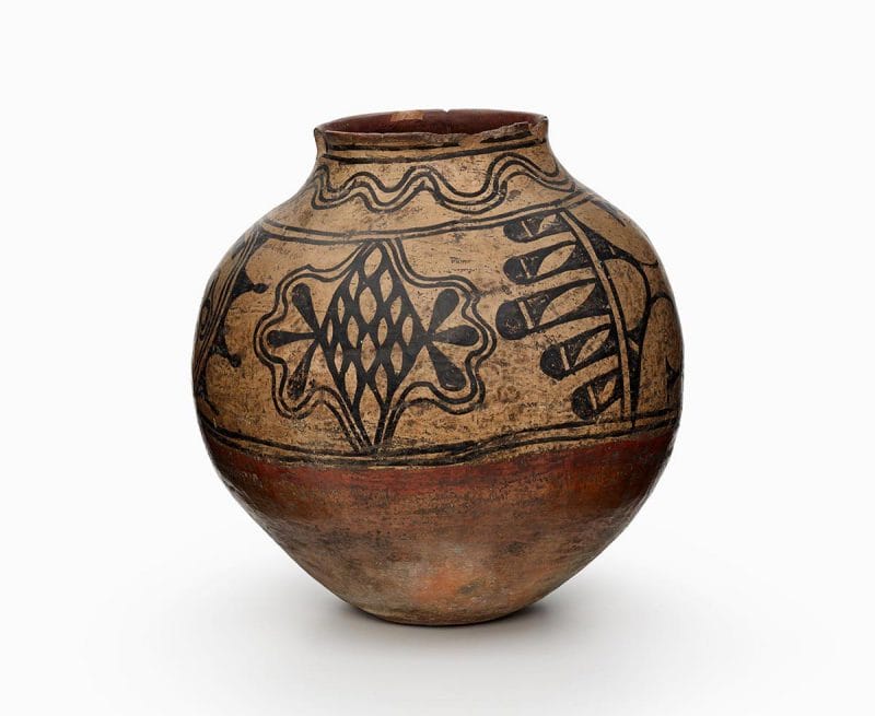 A Powhogeh storage jar with black and red painted decoration.