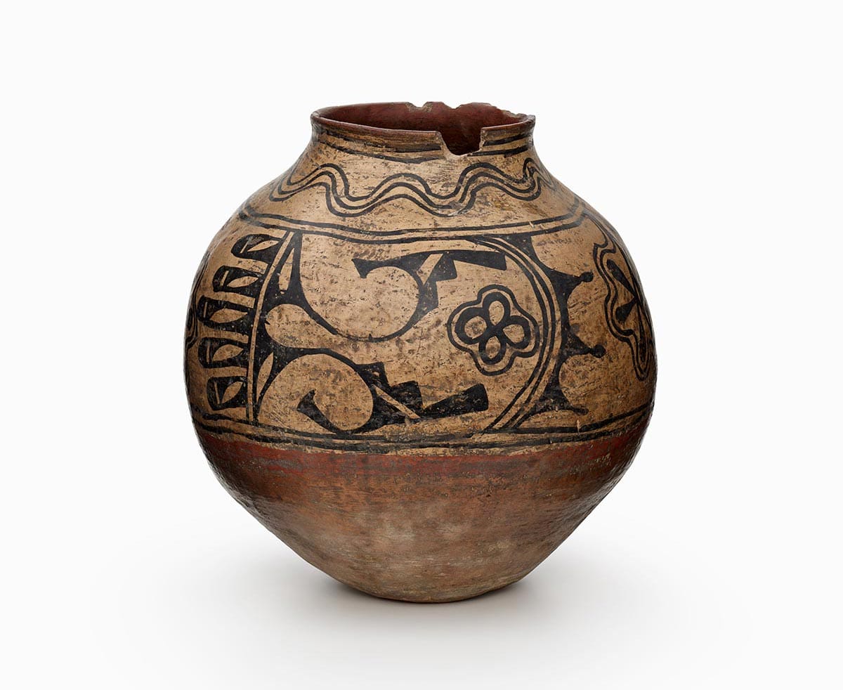 A three-color Powhogeh polychrome storage jar features white slip with black and red painted decoration.