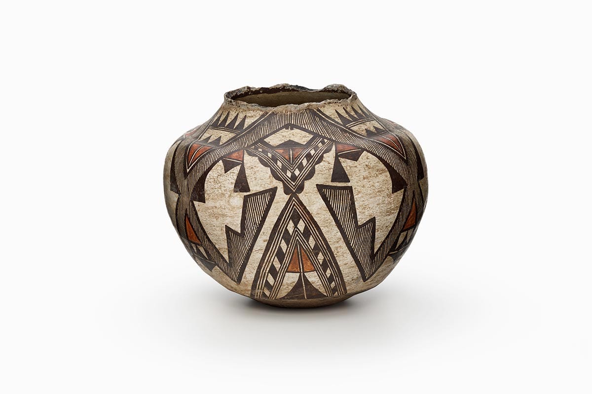 A Kewa storage jar, primarily painted brown, with a rust-orange bottom and black design.