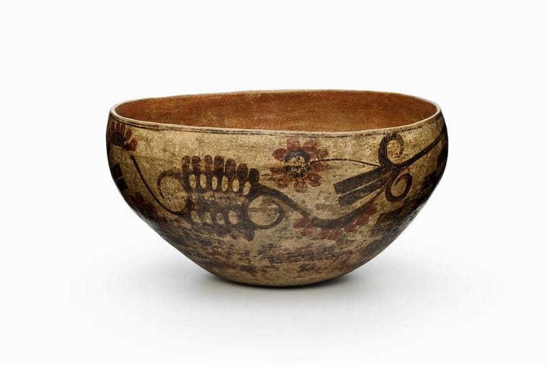 A four-color Acoma polychrome dough bowl features white slip with black, red, and orange painted decoration.