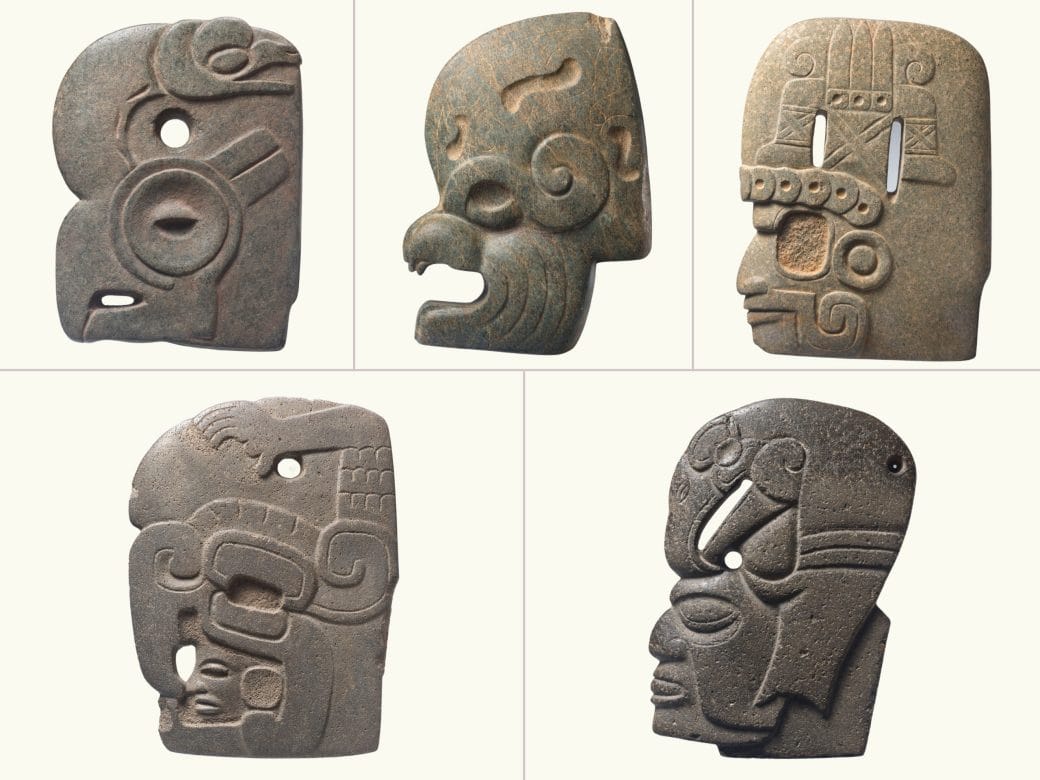 5 stone hachas: 1. A parrot-like face with a snake on the top of its head (top left), 2. A dog or bat's head (top center), 3. A human face with a curling design (a mustache or jaw.), 4. A bird-like figure with a human face. (bottom left), and 5. A human face with a bird on its head.