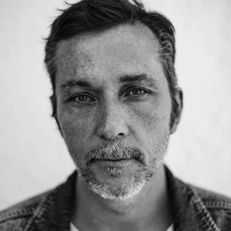 A black-and-white portrait of Laurent Barthelemy.