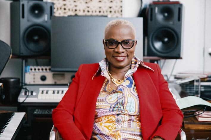 Angélique Kidjo sits smiling in her home studio.