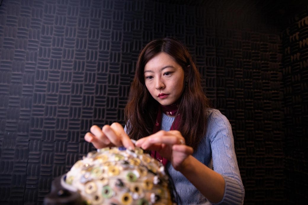 Biyu J. He working on a model of the human brain.