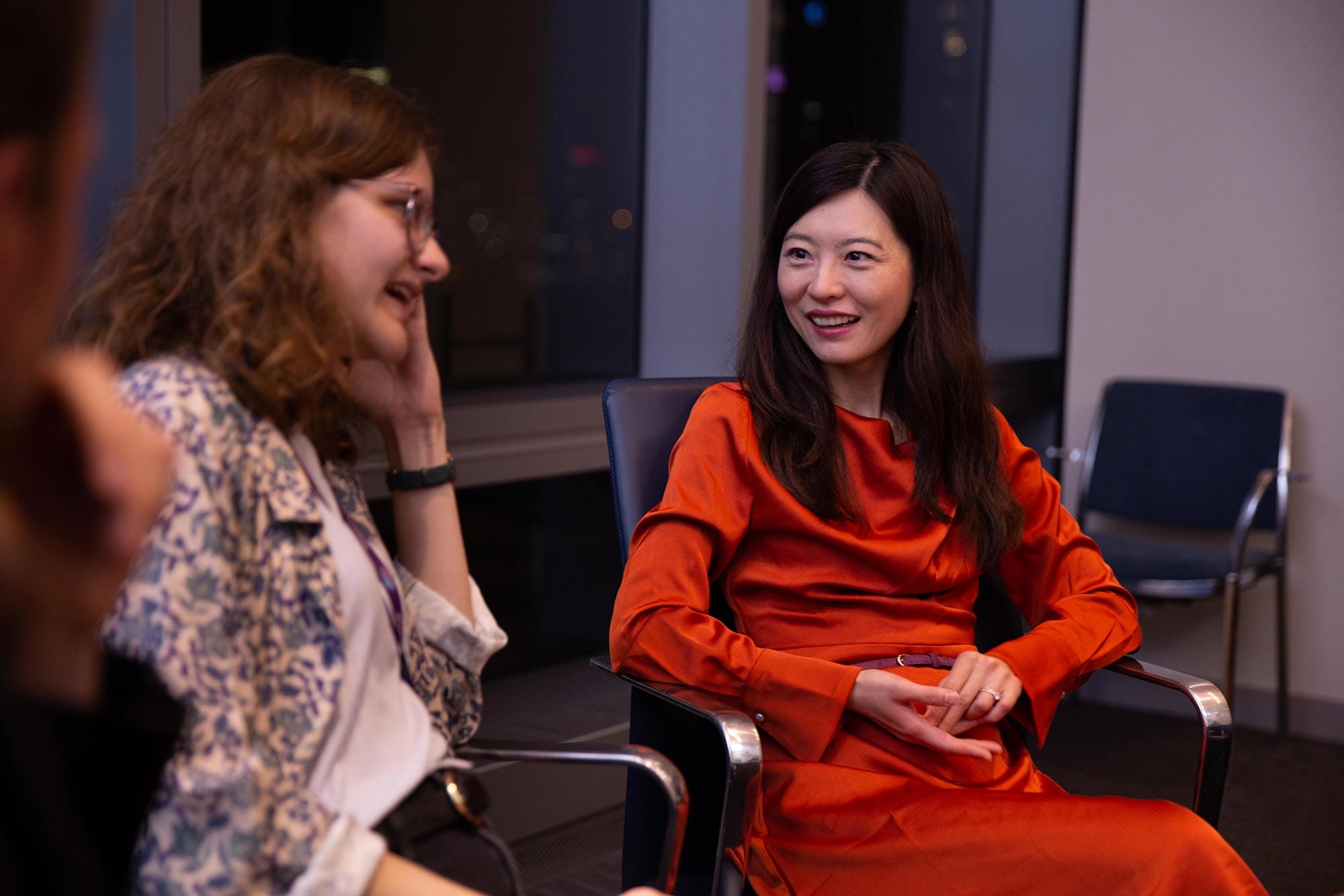 Biyu J. He sitting and talking with her colleagues.