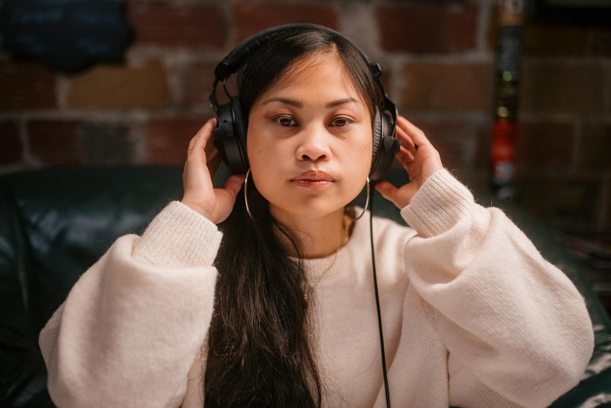 Ruby Ibarra listening to music through a headset.