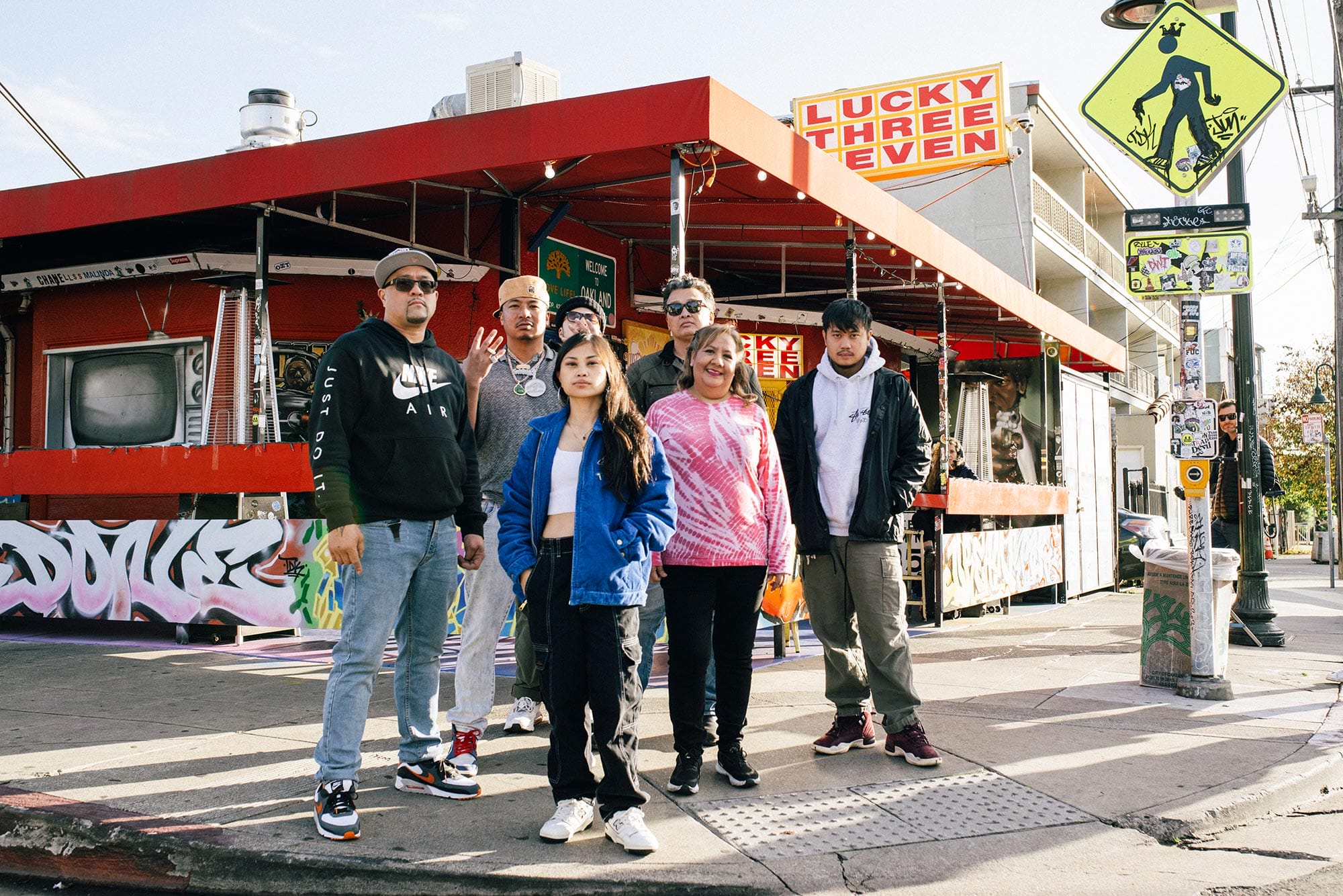 Ruby Ibarra stands with her collaborators in front of a restaurant known for their Filipino food.