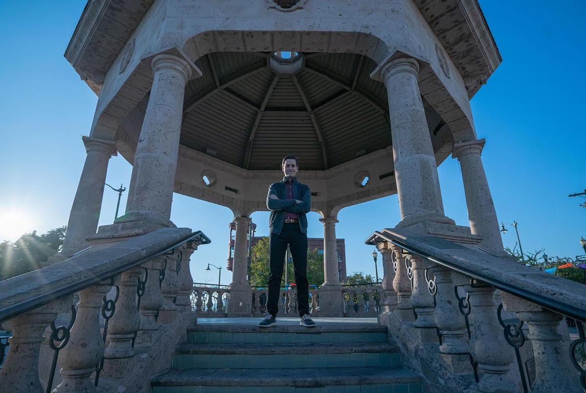 Juan Pablo Contreras stands in the center of a pillared band stand.