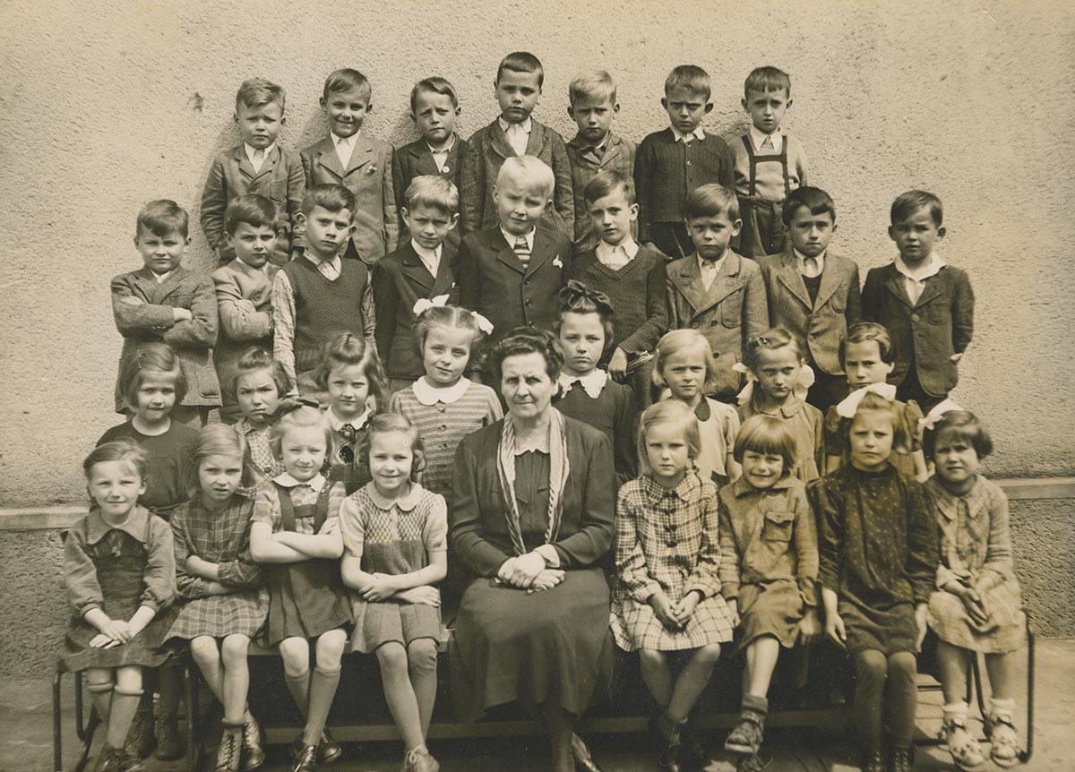 First grade photo of Marica Vilcek, née Gerhath, pictured in the first row to the left of her teacher, c. 1942.