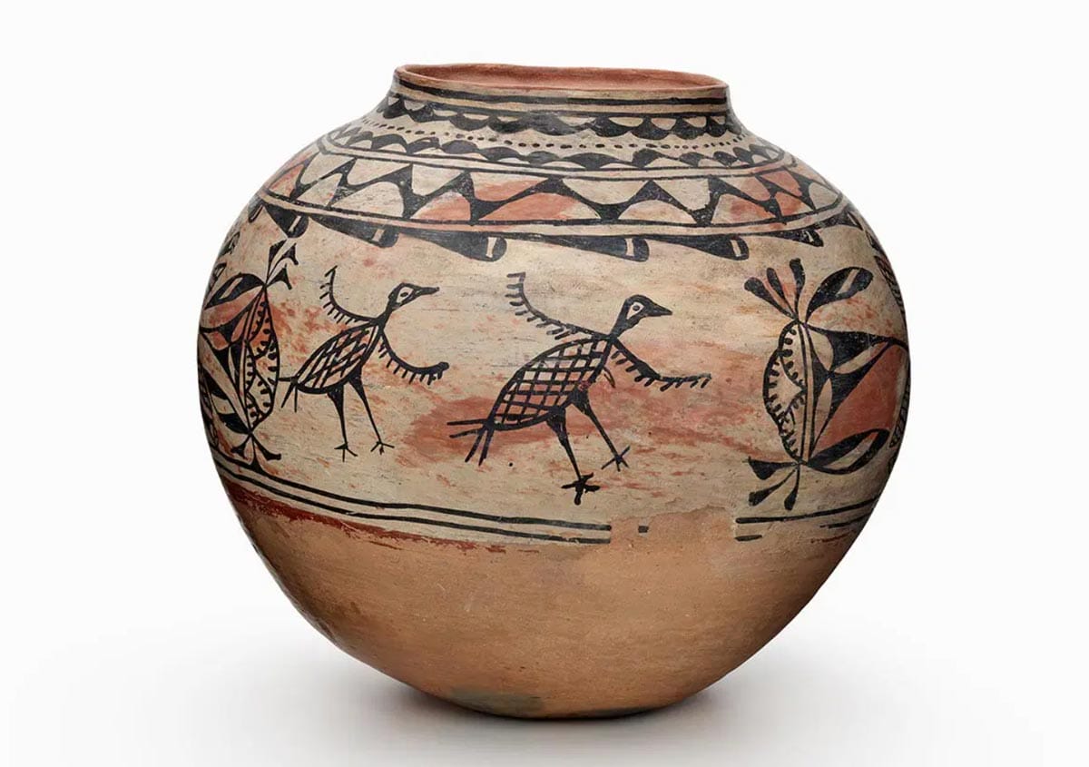 A round pot with bird forms in red and black.