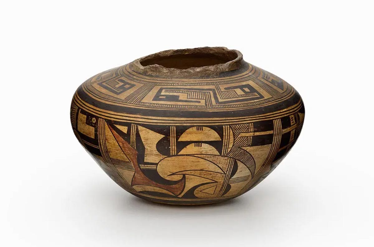 A pot dense with geometric shapes and black lines.