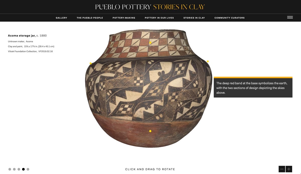 A large Acoma pot with geometric designs in shades of red, cream and black.