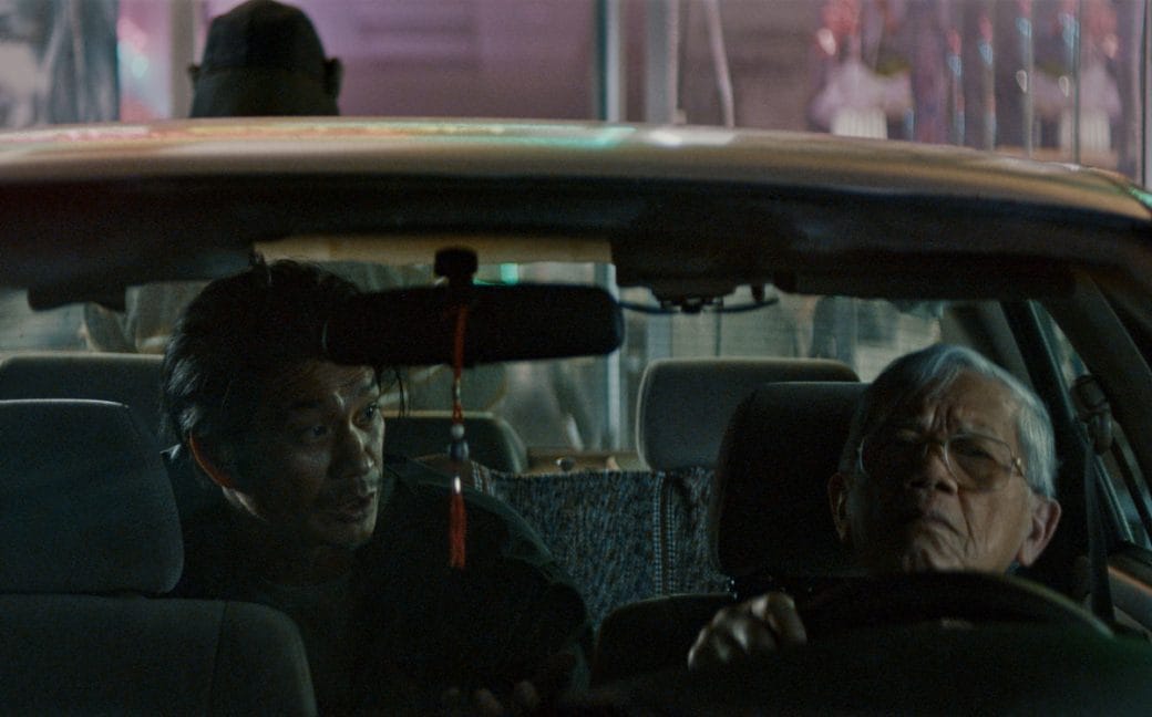 Taxi driver, Long Má, (right) in a tense exchange with a passenger.