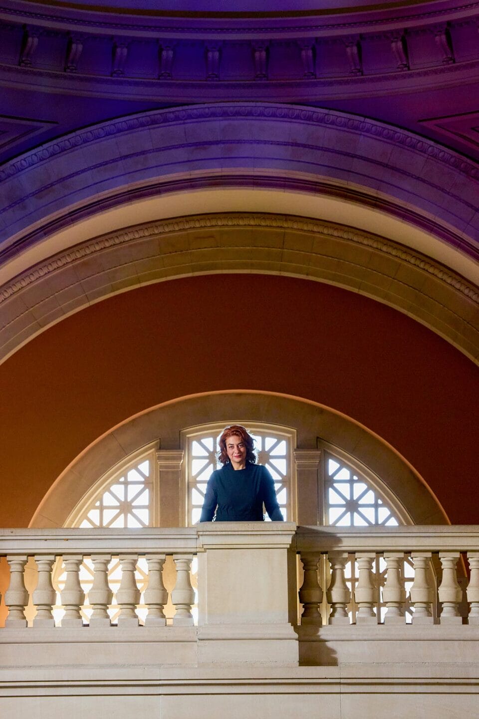 Monika Bincsik standing on the balcony in The Met's grand lobby.