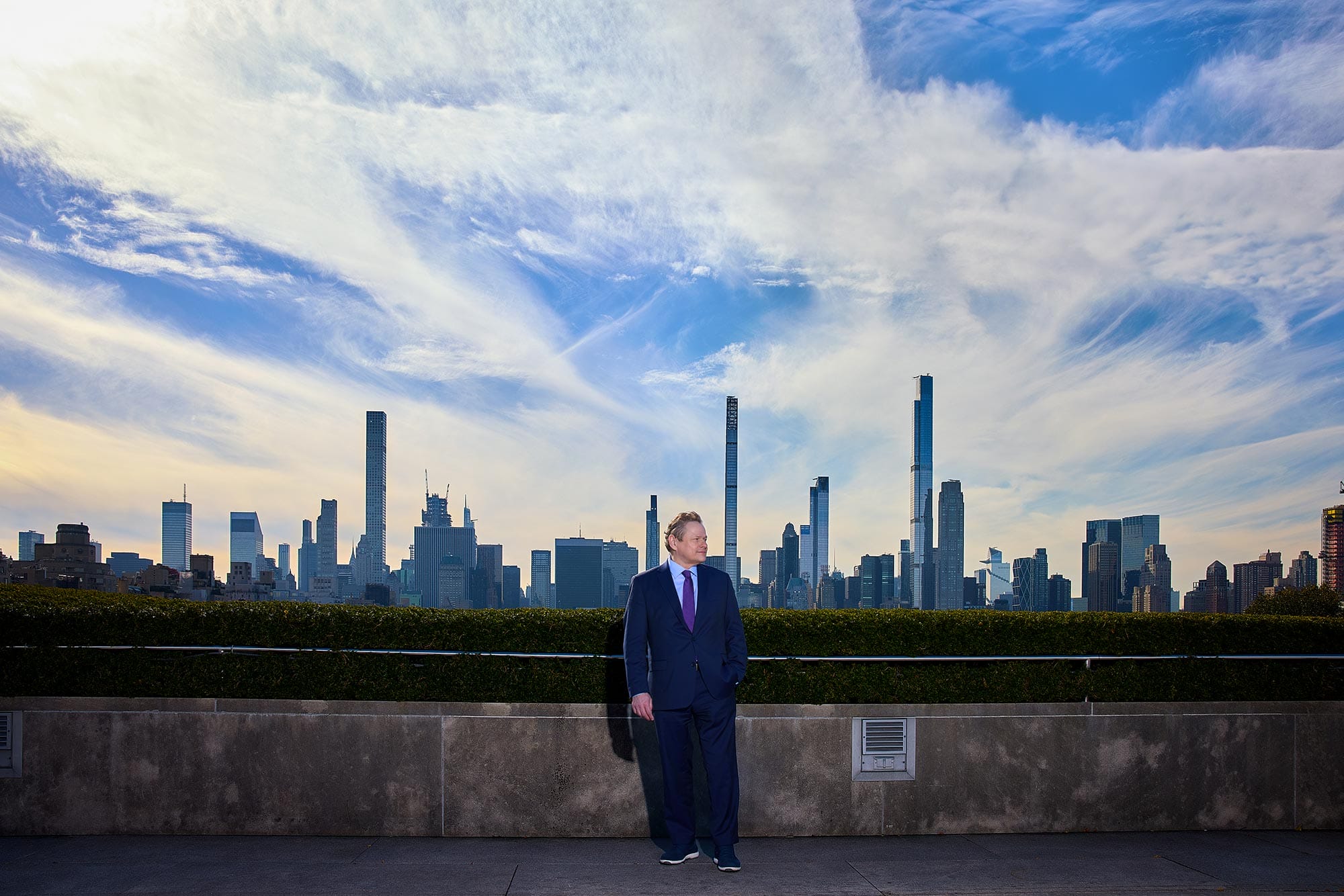 Wolfram Koeppe standing on a rooftop with the New York City skyline behind him.