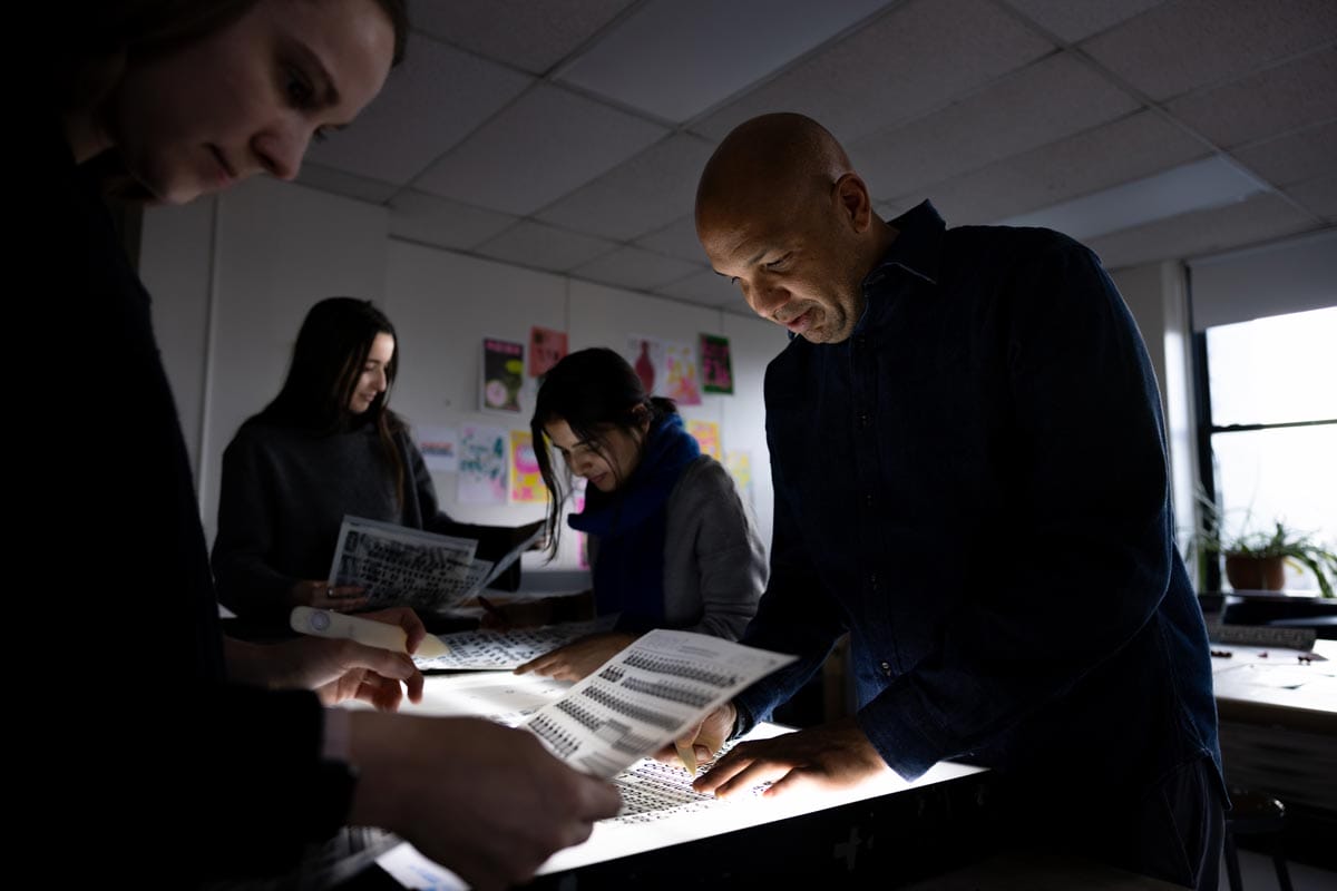 Ramon Tejada works alongside his students and colleagues at low light.