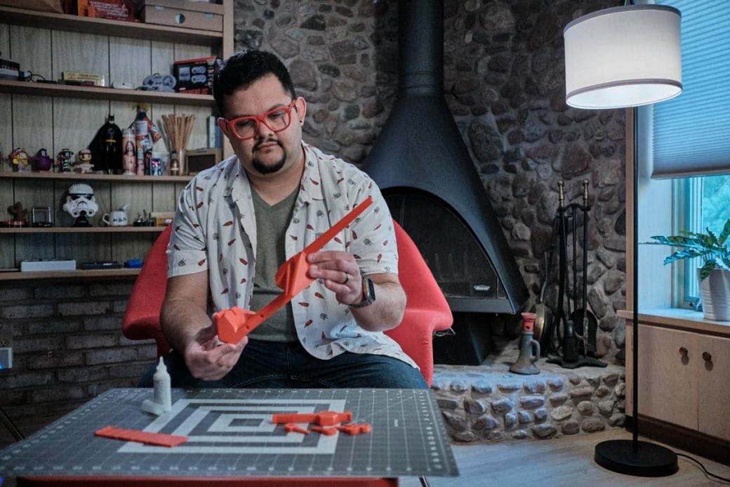 Juan Carlos Noguera sitting and working on the design of a 3D-printed instrument.