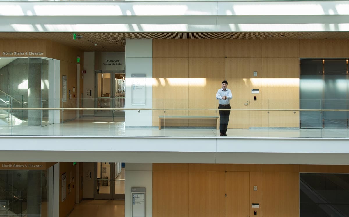 Tomasz Nowakowski stands in the hallway of the University of California, San Francisco in front of the research laboratories. 