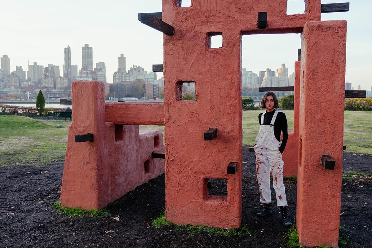 Maryam Turkey standing beneath the sculpture she installed on Governor's Island. 