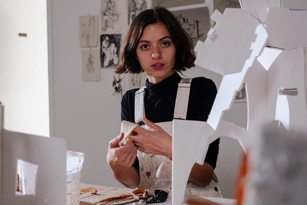 Maryam Turkey working with model structures in her studio.