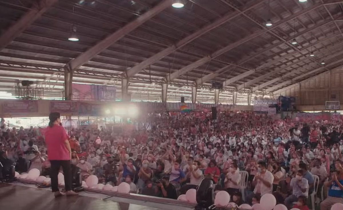 Former Vice President of the Philippines Leni Robredo at a rally held in a large indoor venue with lots of participants.