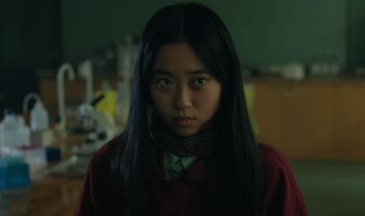 Protagonist Wei has long, black hair and is wearing a red sweater.