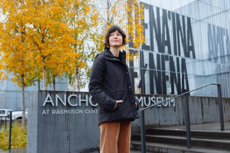 Francesca standing outside of the entrance to the Anchorage Museum in front of the signage.