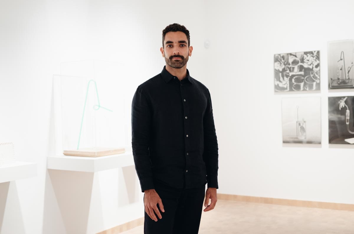 Bernardo standing in the gallery space at ISLAA.