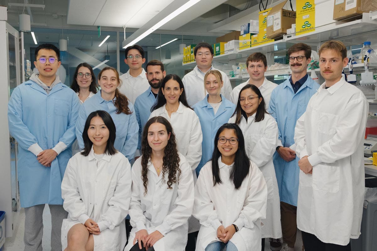 Maayan Levy stands in the center with her lab members surrounding her in the Levy Lab.