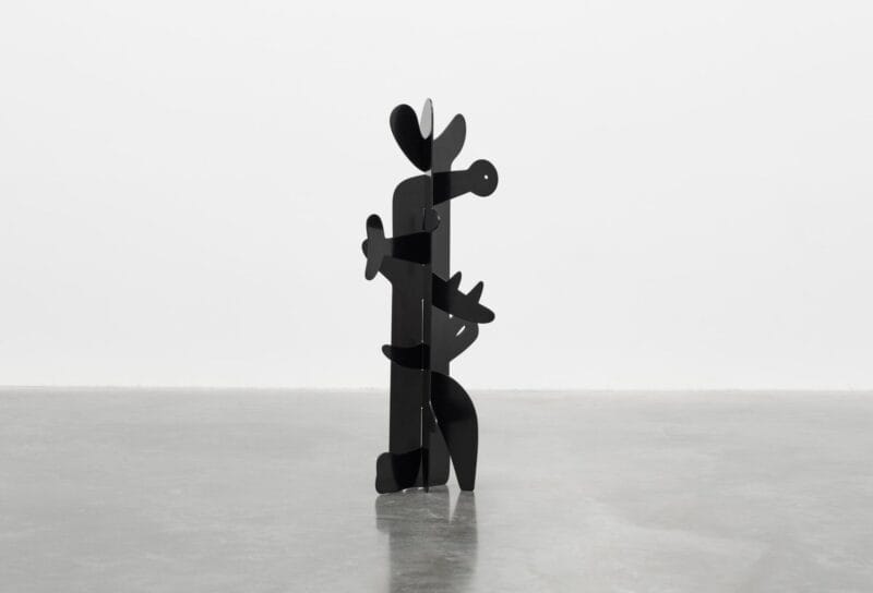 A black metal sculpture in a gallery space.