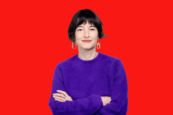 A portrait of Francesca Du Brock against a red background.